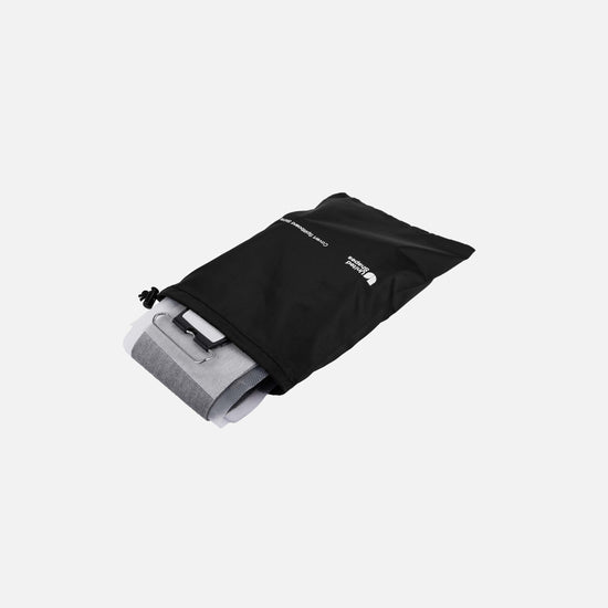 United Shapes Covert pre-cut splitboard skins peering out a black drawstring bag.