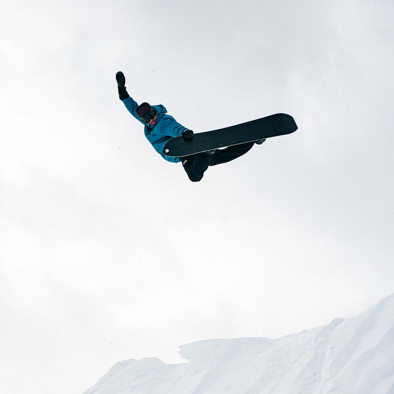 Snowboarder doing a method grab with the Horizon united shapes snowboard