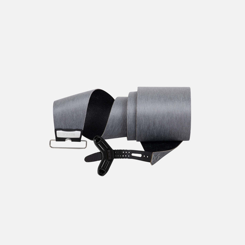 Rolled up United Shapes Covert pre-cut splitboard skins, on a grey background.