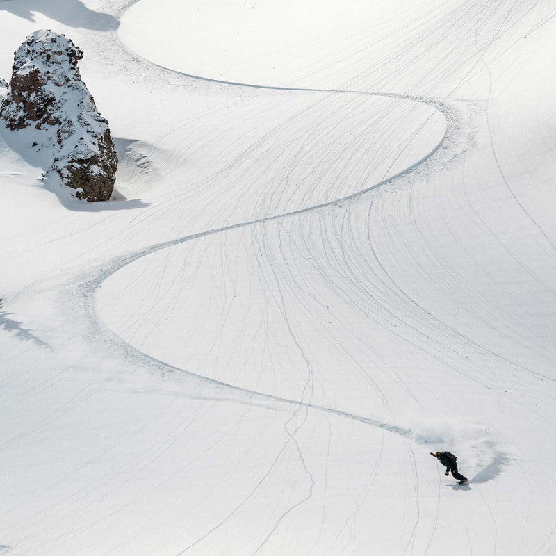 Snowboarder tracks in powder on mountain rider using Experiment by United Shapes